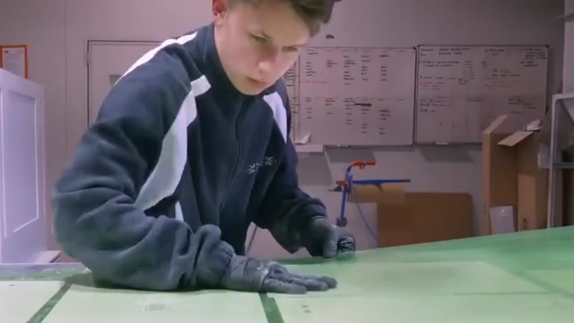 young man preparing cabinets for painting