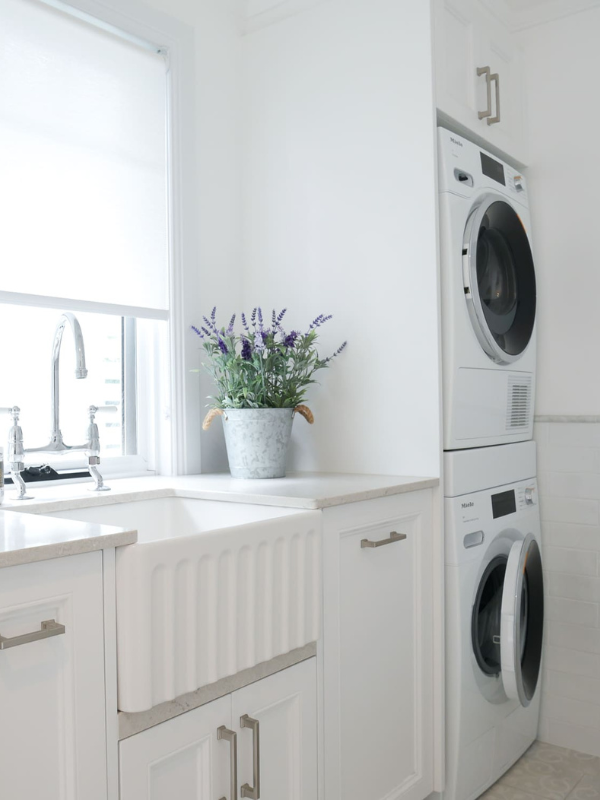 Laundry Cabinet Painted Modern white laundry room with shaker-style cabinets, butlers sink in crisp white.