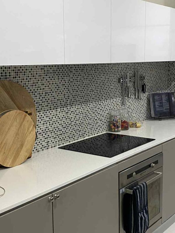 kitchen cabinet in brown colour with small blue tiles for splashback