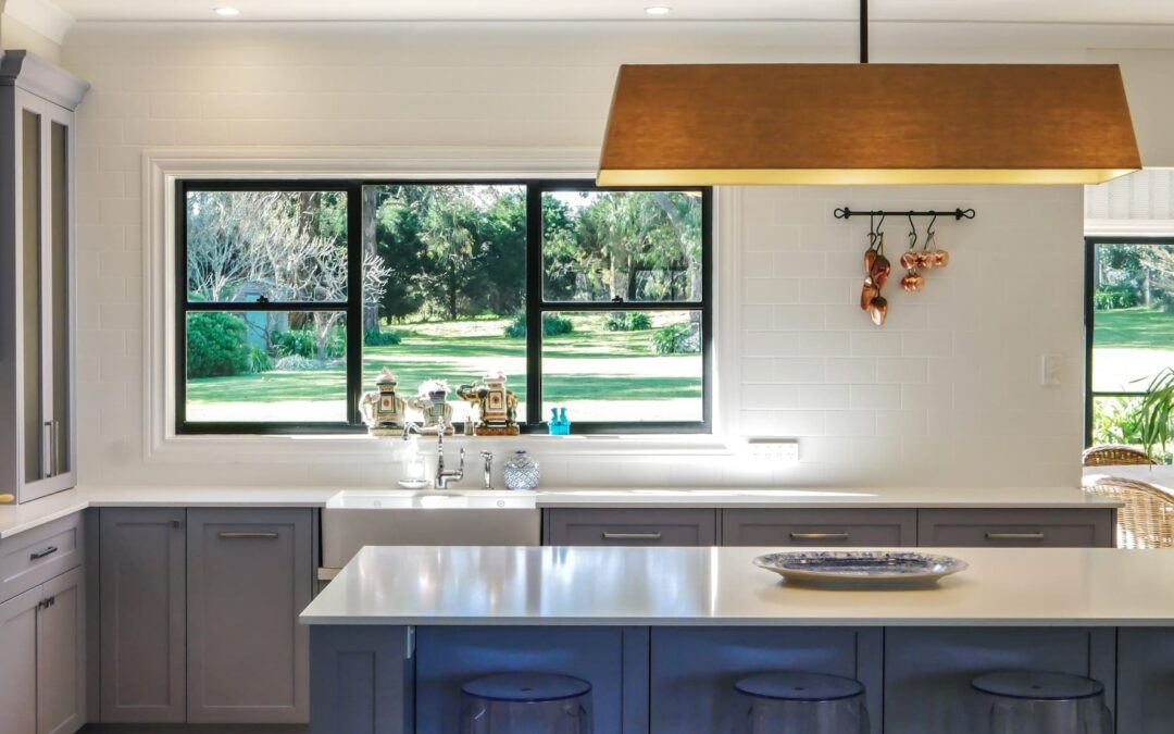 painted kitchen cabinets in blue shade with island and stone benchtop