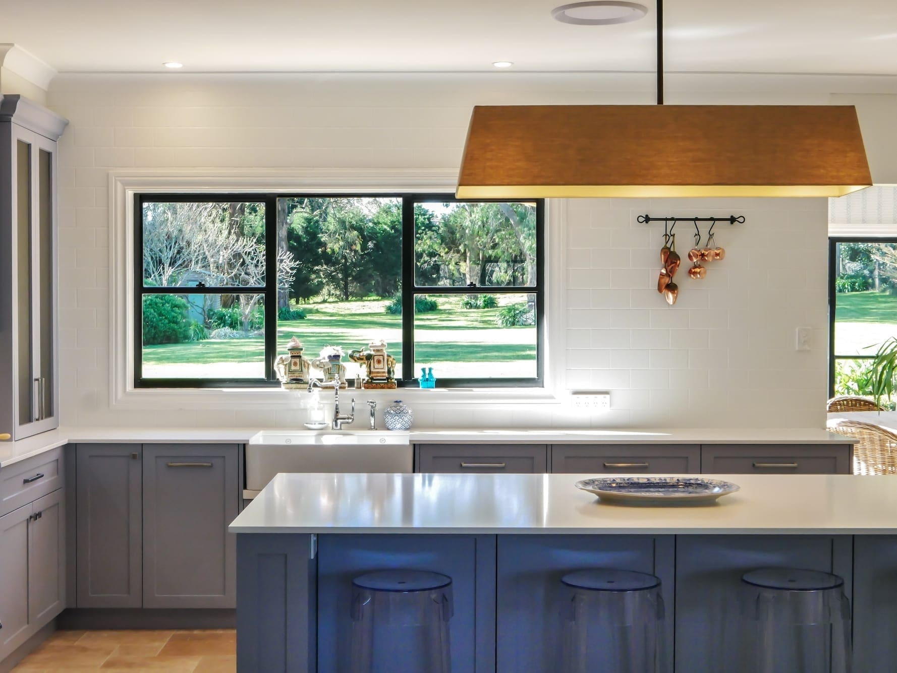 painted kitchen cabinets in blue shade with island and stone benchtop