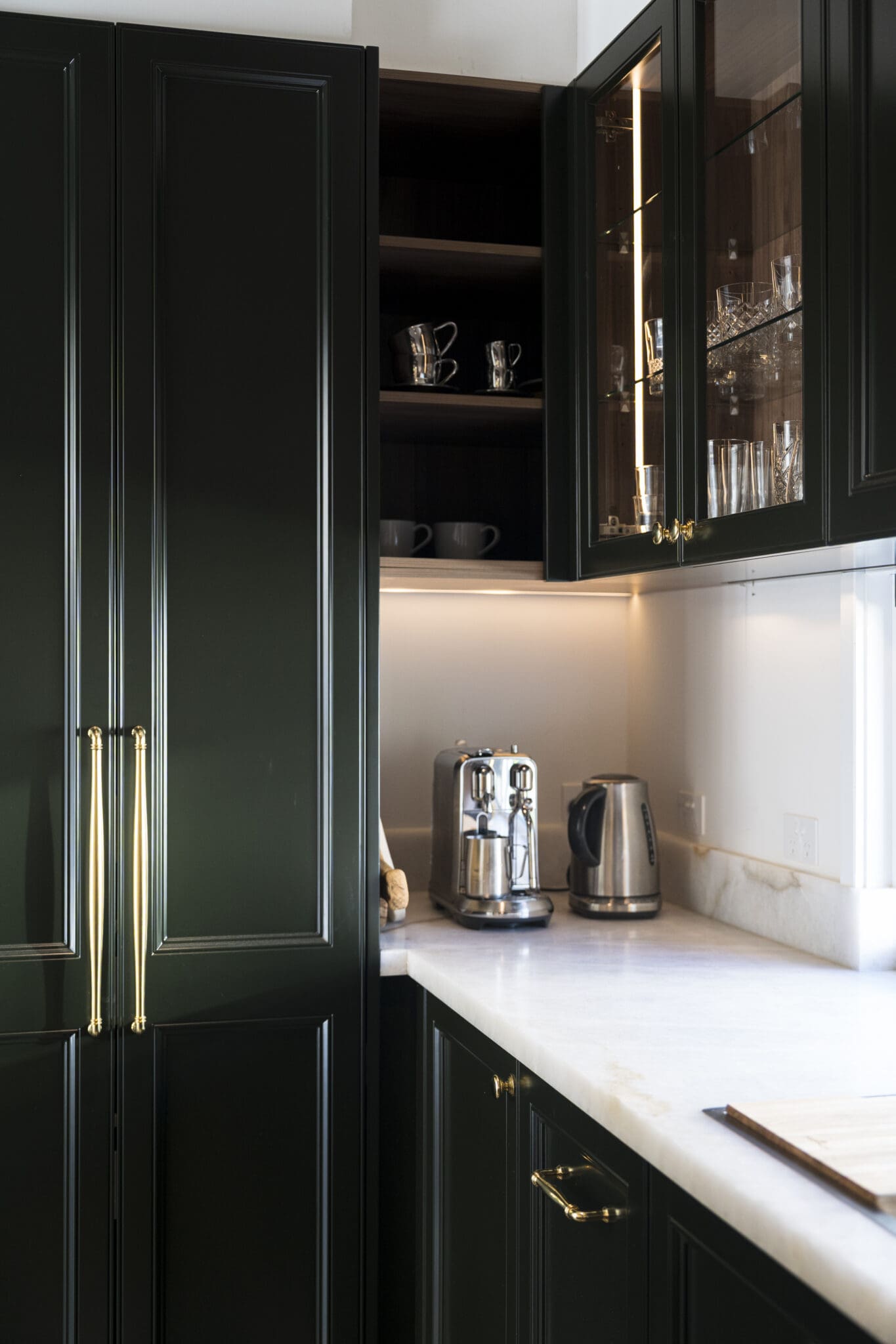 A modern coffee nook painted in Polyurethane Black Cockatoo, featuring sleek cabinetry, a matte black finish, and a stylish, built-in coffee station.