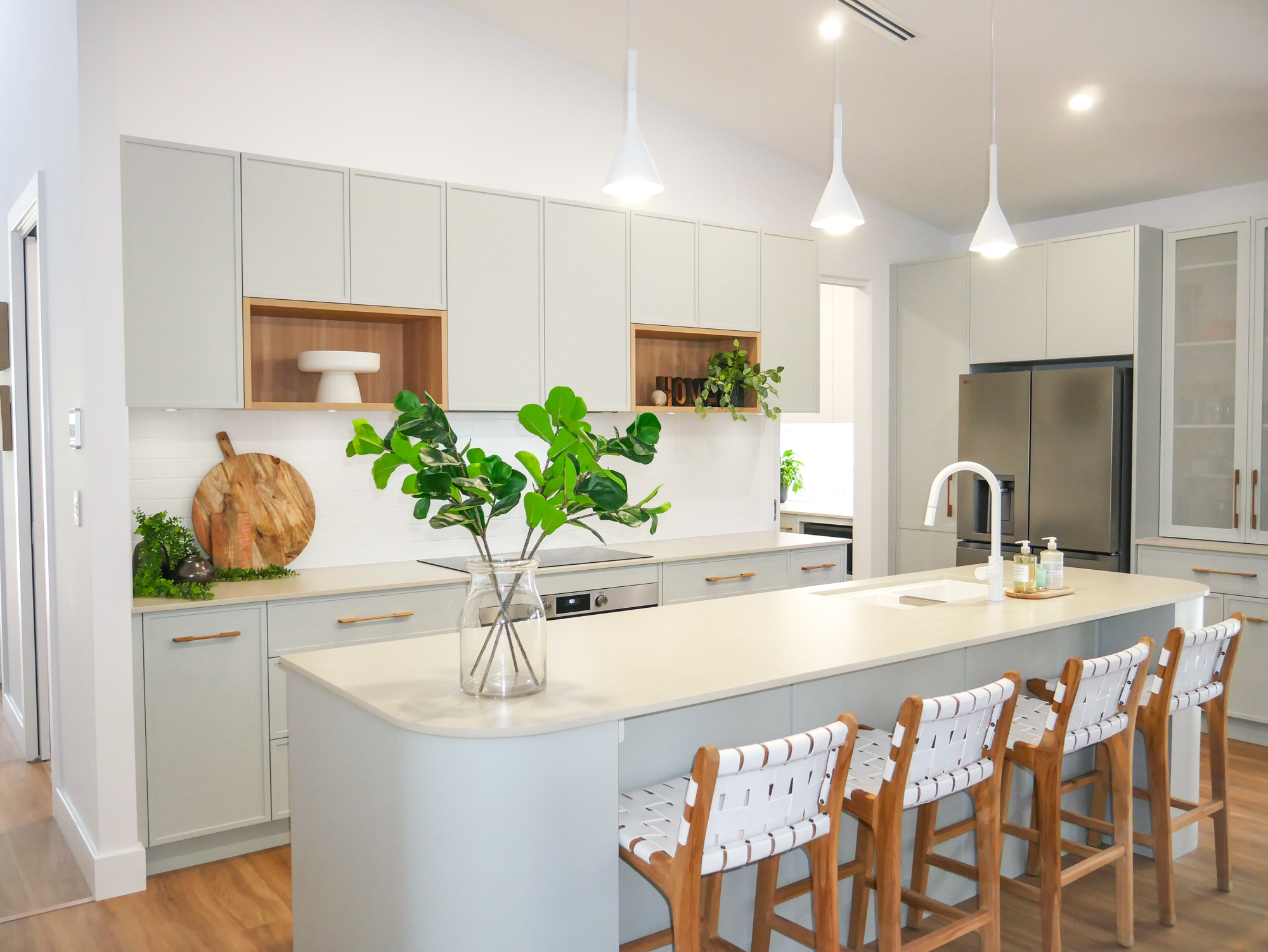 muted green kitchen colour scheme with timber elements